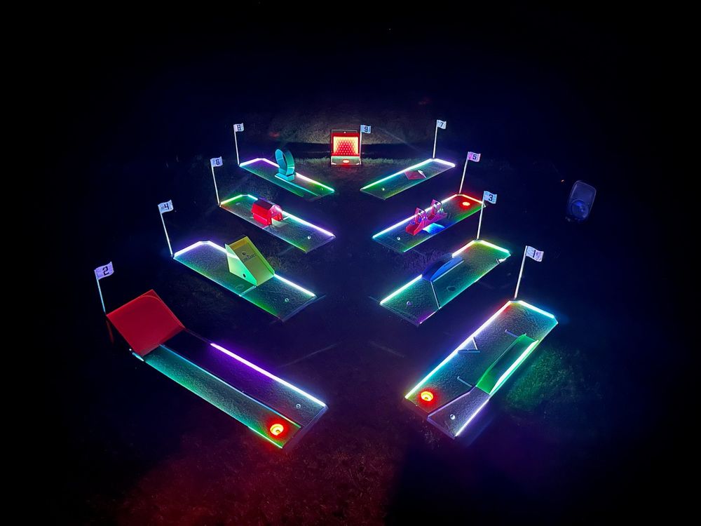 An Alumi Games LED mini golf course set up at an event